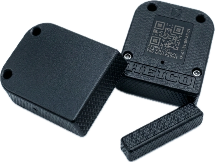 Disassembled AEROSENS BLE tag manufactured by HEICO, showing the FAA-PMA marking, FCC ID, and serialized QR code on the housing